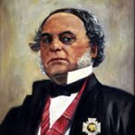 official professional portrait of older manwearing tuxedo, winged collar, medal on lapel